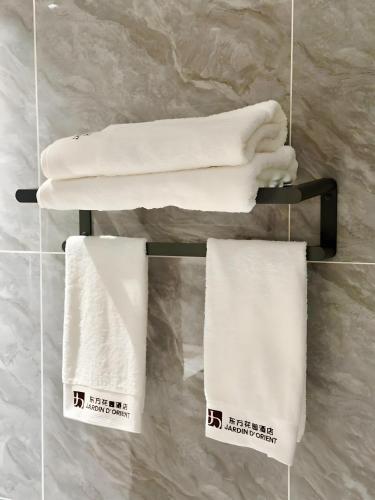 a group of towels hanging on a rack in a bathroom at Jardin d'orient in Dakar