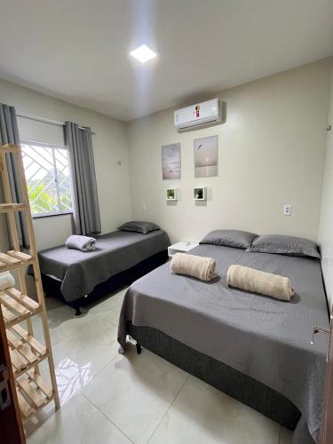 a bedroom with two beds and a ladder at Chalé de Serra 02 em Viçosa do Ceará in Viçosa do Ceará