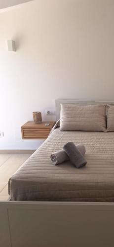 a stuffed animal is sitting on a bed at Apartamentos QEli in Son Carrio