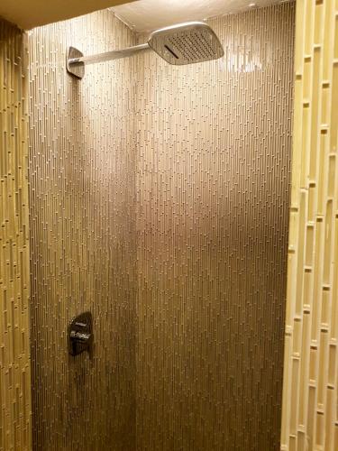 a shower in a bathroom with a glass door at Bloom! exclusive boutique b&b in Playa del Carmen