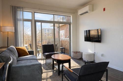 a living room with a couch and chairs and a table at East Side Luxury 1BR Apt - Near Brady and Fiserv with Balcony - Sleeps 5 in Milwaukee