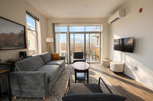 a living room with a couch and a tv at East Side Luxury 1BR Apt - Near Brady and Fiserv with Balcony - Sleeps 5 in Milwaukee