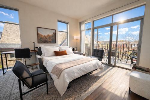 a bedroom with a large bed and a balcony at East Side Luxury 1BR Apt - Near Brady and Fiserv with Balcony - Sleeps 5 in Milwaukee