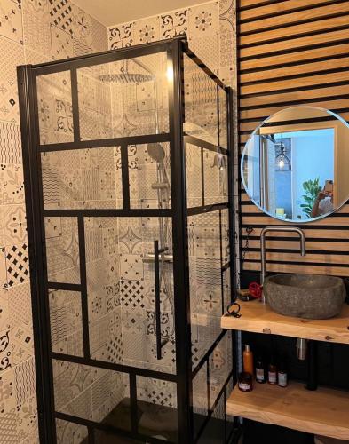 a bathroom with a mirror and a sink at Vacances in Cavalaire-sur-Mer