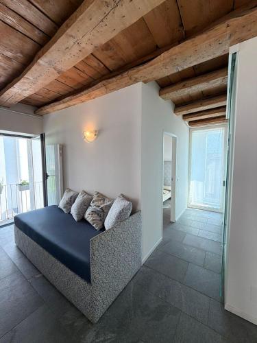 a bedroom with a bed in a room with windows at La Porta Segreta del Rustico in Gordola