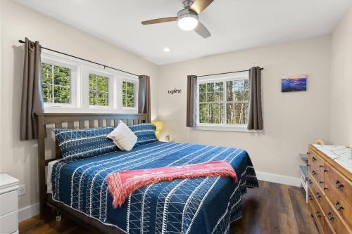 a bedroom with a bed and two windows at The Overlook at Orchard Hills in Bernard