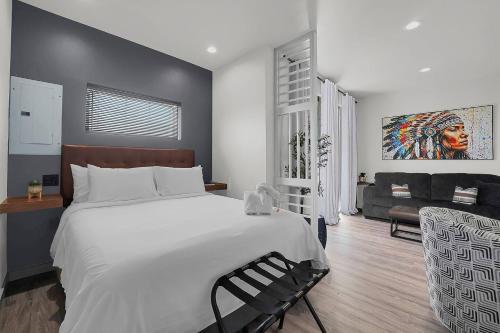 a bedroom with a large white bed and a couch at Medicine Park Flat's #05 in Medicine Park