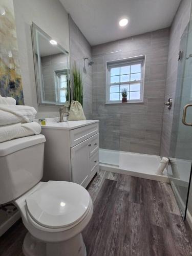 a bathroom with a toilet and a sink and a shower at Brand new everything! Adjustable beds! Best House in Lawton