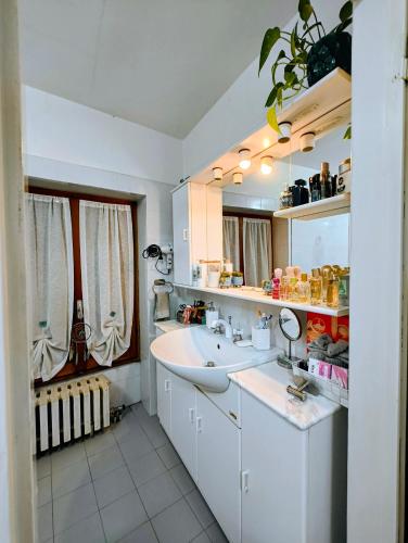 a white bathroom with a sink and a mirror at Alloggio DON ESTEBAN in Santa Maria della Versa