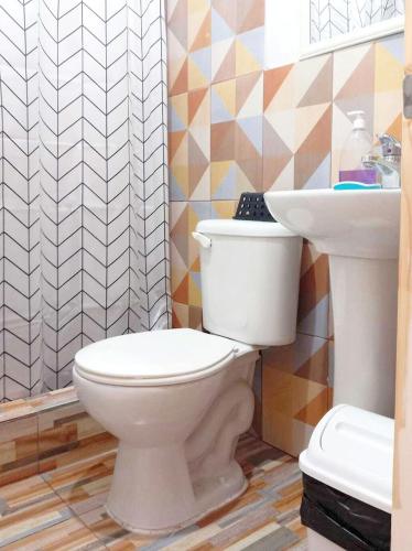 a bathroom with a toilet and a sink at CASA HOSTAL LA PASKANA ATACAMEÑa in San Pedro de Atacama