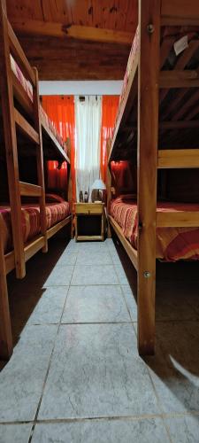 a room with three bunk beds in a house at Cabaña Puntana in La Punta
