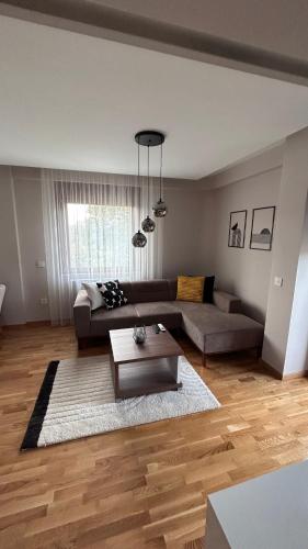 a living room with a couch and a table at SiM Lux in Čačak