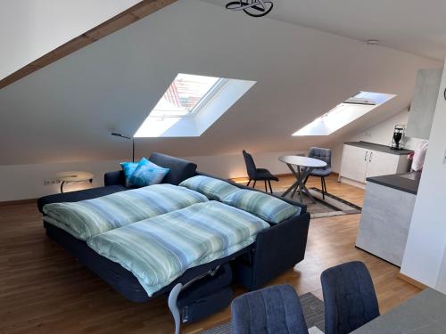 a living room with a couch and a table at Rooftop Apartment in Kornwestheim