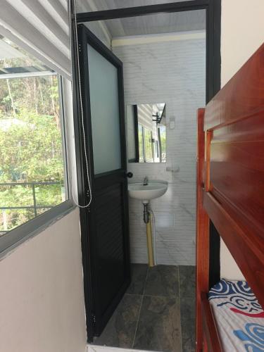 a bathroom with a sink and a mirror at Cabaña La Rivera in Macanal