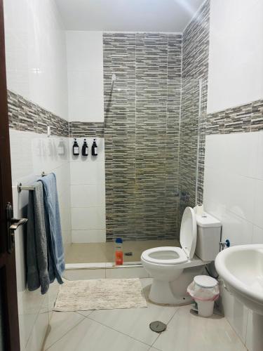 a bathroom with a toilet and a sink at Near Beach 2 Bed Apt in Tarrafal
