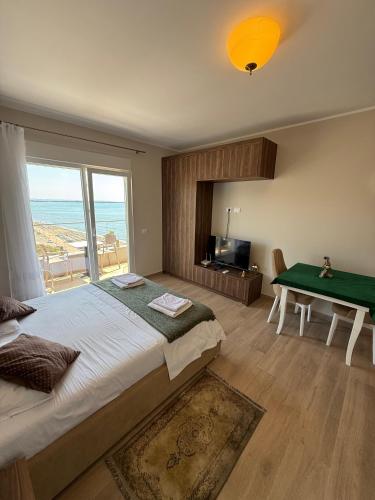 a bedroom with a bed and a view of the ocean at Sea La Vie in Shëngjin