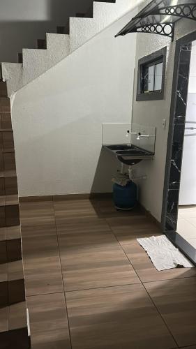 a bathroom with a sink and a staircase at Temporadaemjaua in Camaçari