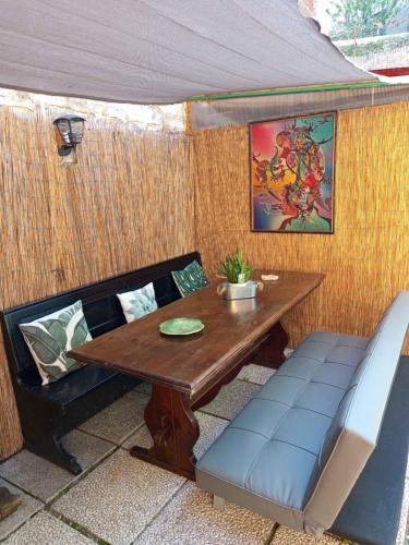 a table and chairs in a covered area with a table at La Yucca in Dolceacqua