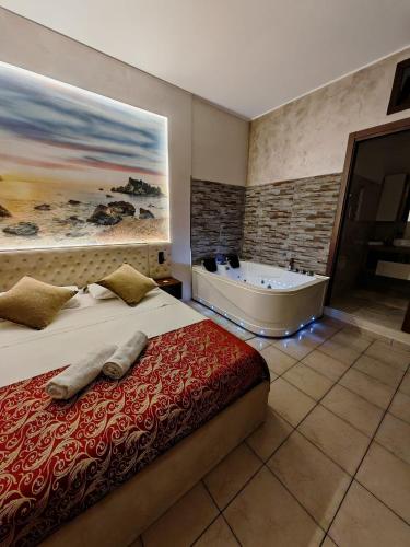 a bedroom with a bed and a bath tub at Agata House in Catania