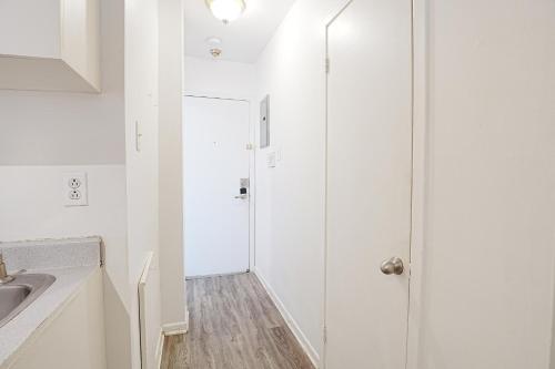 a white bathroom with a shower and a sink at Comfort Residence in Montreal