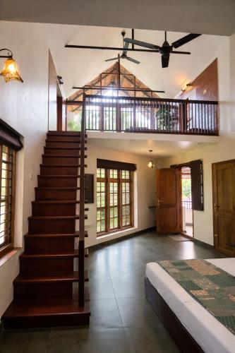 a room with a staircase and a stair case at Maleyam Homestay in Kozhikode