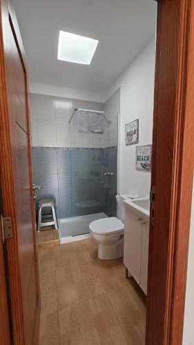 a bathroom with a toilet and a shower and a sink at Can Blum in La Asomada
