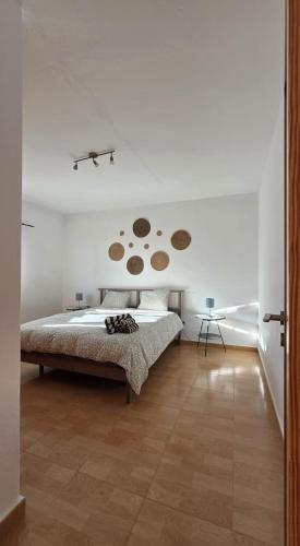 a bedroom with a bed in a white room at Can Blum in La Asomada