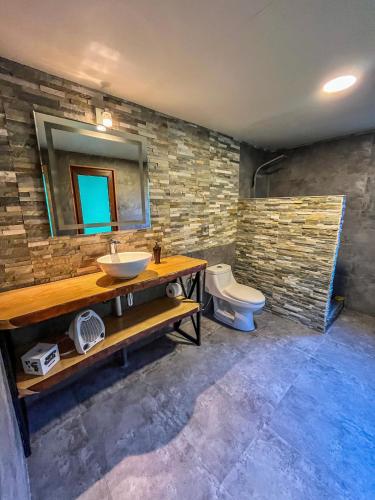 a bathroom with a sink and a toilet at Hotel Neyün La Junta in La Junta