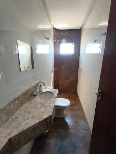 a bathroom with a sink and a toilet at APART HOTEL Lar Doce Lar 2 & 7 in Arcos