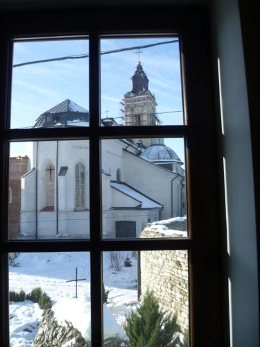 a window view of a building in the snow at Home Hotel in Kamianets-Podilskyi