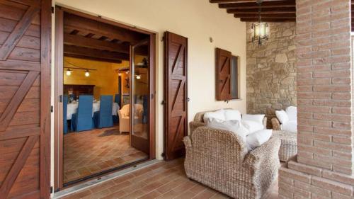 a room with two chairs and a sliding glass door at Umbria Genius Loci Farmhouse in Gaglietole