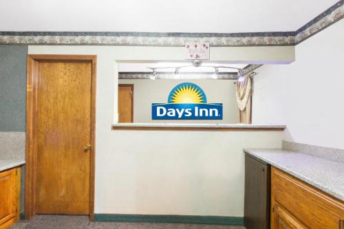 a room with a days inn sign on the wall at Days Inn by Wyndham Erick in Erick