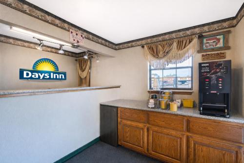 a bar in a restaurant with aadyim sign on the wall at Days Inn by Wyndham Erick in Erick