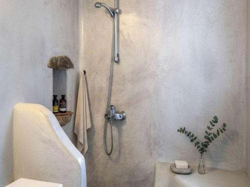 a bathroom with a shower with a sink and a toilet at Kalafatis Stay with Private Pool in Kalafatis