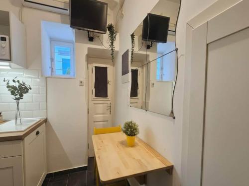 a small kitchen with a wooden table in a room at Mykonos Town Home for Two in Megali Ammos