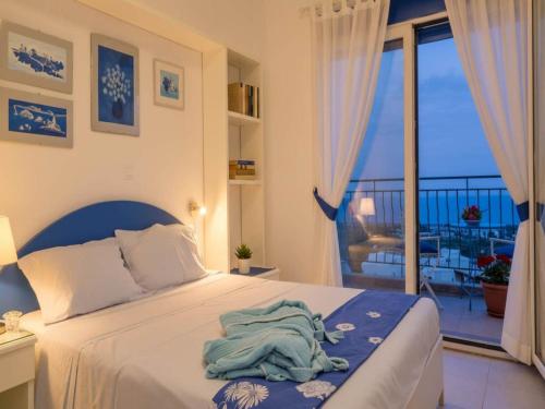 a bedroom with a bed and a balcony at Rhodes Retreat with Private Pool in Kalathos