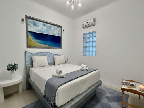 a bedroom with a large bed in a room at Panormos Retreat with Pool in Mikonos
