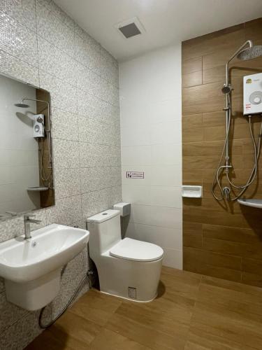 a bathroom with a toilet and a sink at MinimalYala in Yala