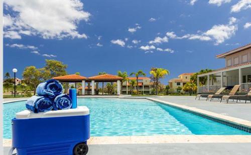 a pool with a blue fountain with blue roses at Solimar Villa Family Vacation Spot in Playa de Guayanes