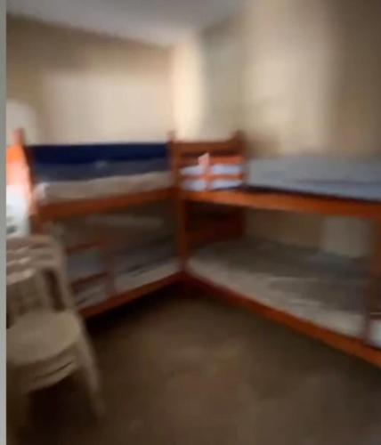a room with a bed and a desk and chairs at Estância 7 praias in São Paulo