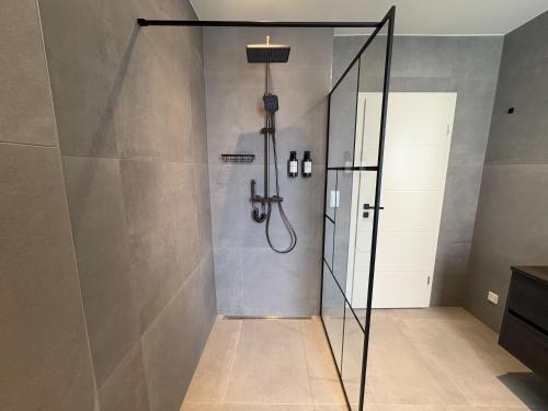 a shower with a glass door in a bathroom at Bielefeld Grand Central Residence in Bielefeld