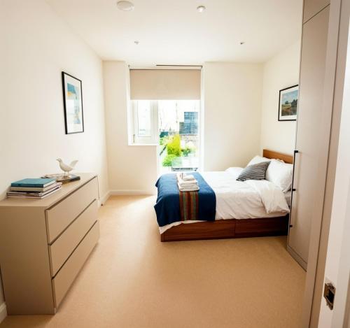 a bedroom with a bed and a window at CityScape - Greenwich 2-Bed flat in London