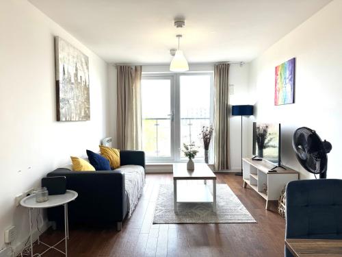 a living room with a couch and a table at VIPAbodes at The Nankeville Woking in Woking