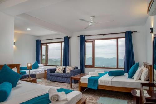 a bedroom with two beds and a couch at Bethel Rest Homestay in Kandy