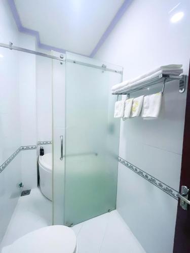 a bathroom with a glass shower and a toilet at Diamond Suite Dai Nam Hotel in Can Tho