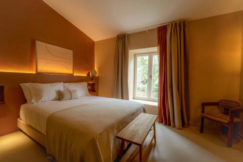 a bedroom with a large bed and a window at Solar Alvura Boutique Hotel in Moncarapacho