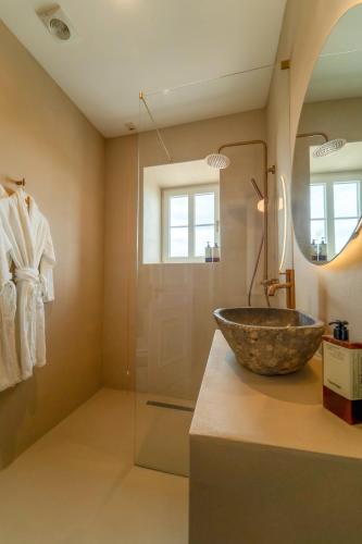 a bathroom with a large bowl sink on a counter at Solar Alvura Boutique Hotel in Moncarapacho