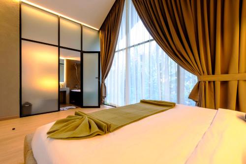 a bedroom with a bed and a large window at SWOI LOFT UMALAs Designer 2BR Private Pool Villa in Kerobokan