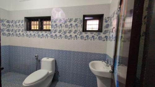 a bathroom with a toilet and a sink at Winter Bloom Homestay Munnar in Munnar
