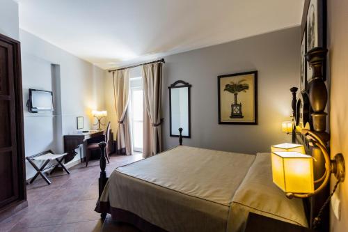 Säng eller sängar i ett rum på Hotel dei Coloniali